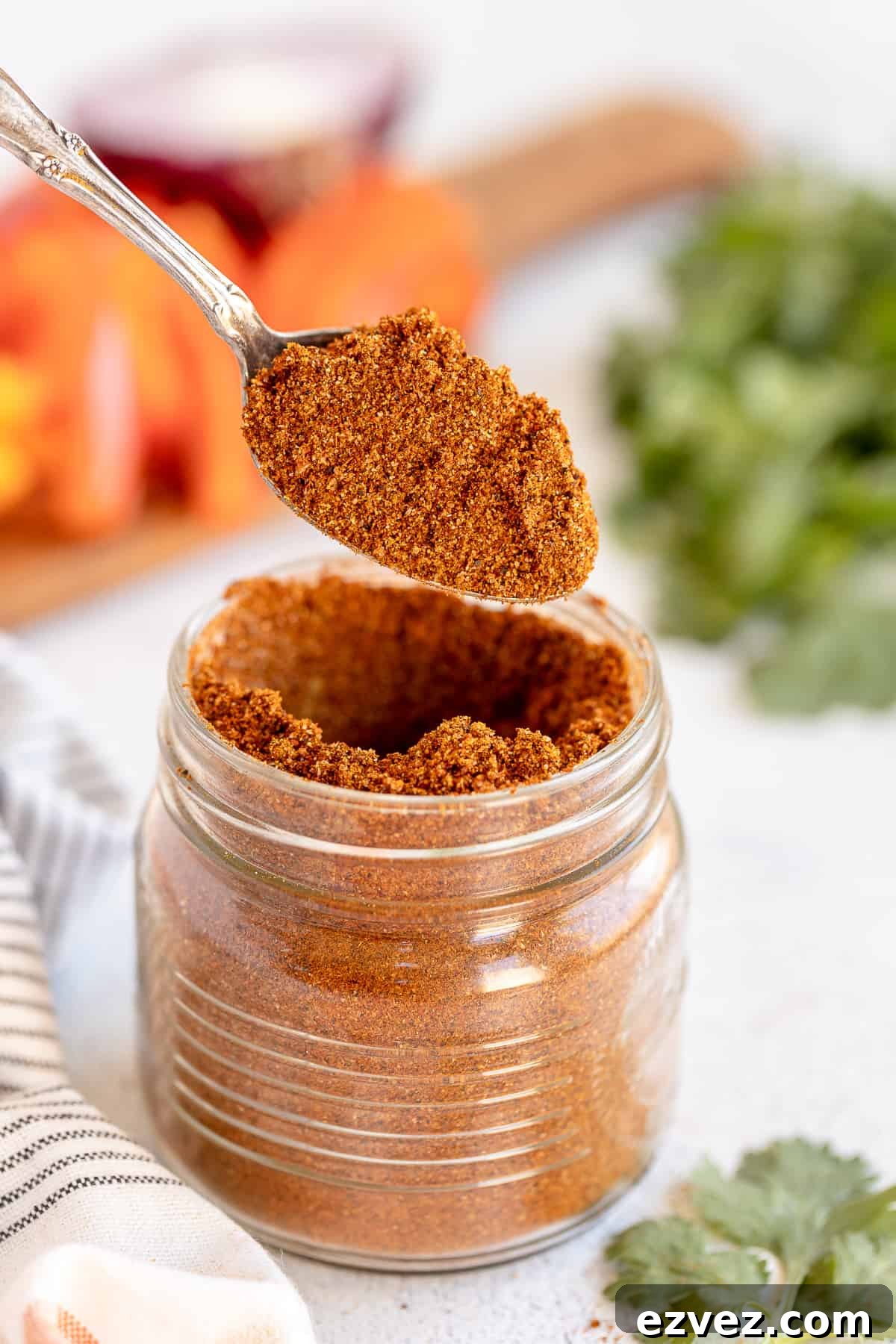 Homemade Fajita Seasoning Blend for Authentic Mexican Flavor 6 A spoon lifts fajita seasoning from a mason jar.