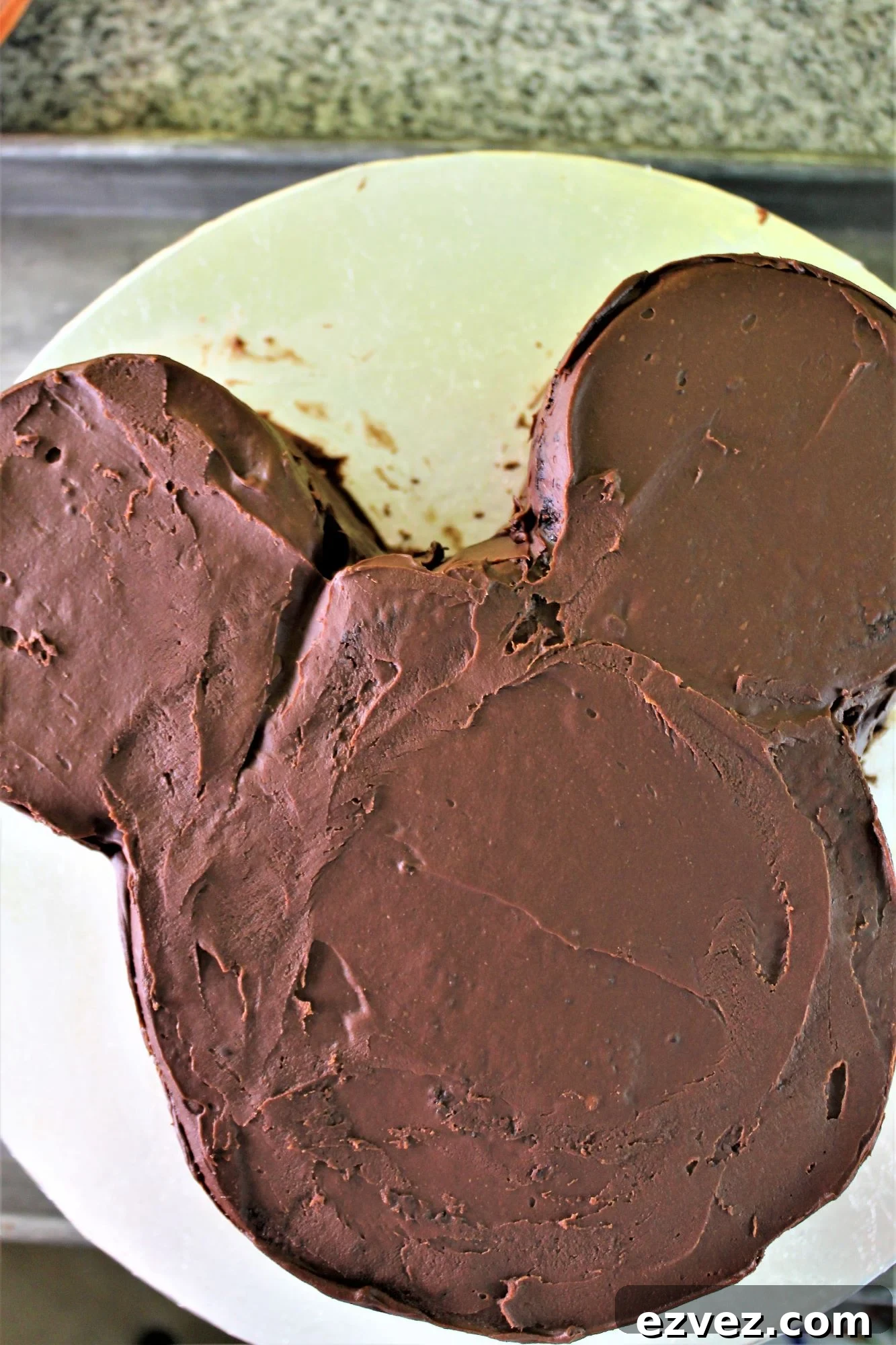 Decadent Gluten-Free Chocolate Cake Recipe for Perfect Texture 11 mickey mouse shaped cake with a crumb coat of frosting.