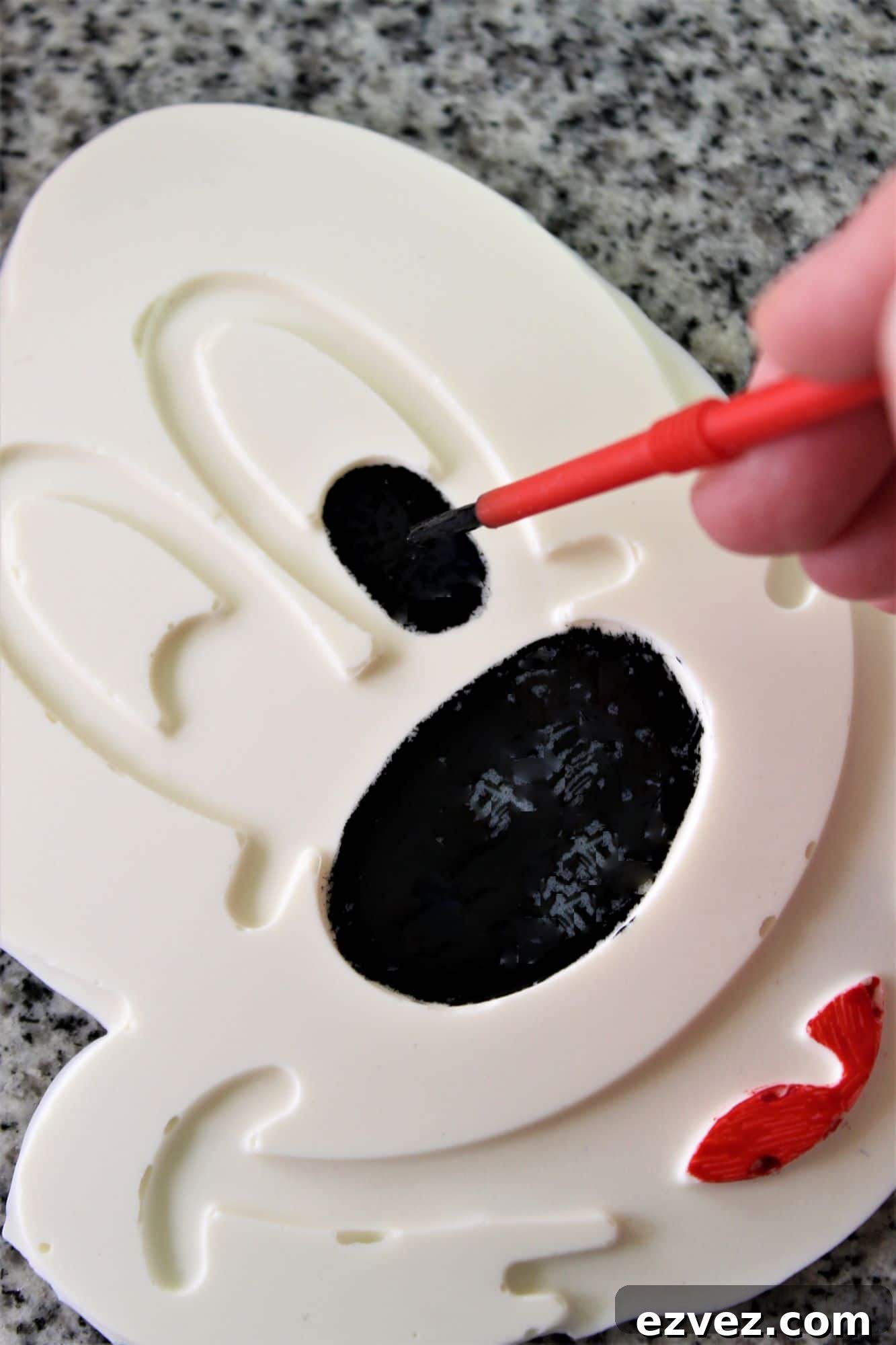 Decadent Gluten-Free Chocolate Cake Recipe for Perfect Texture 17 painting red and black gel food colors on the white chocolate mickey face.