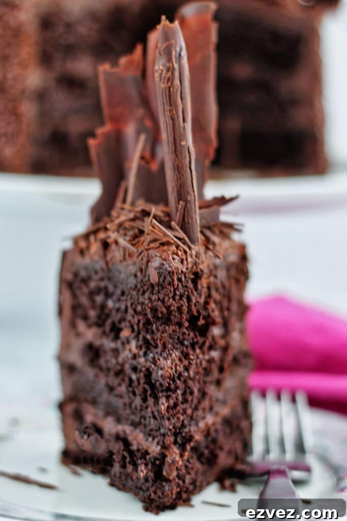 Decadent Gluten-Free Chocolate Cake Recipe for Perfect Texture 7 slice of chocolate cake on plate with fork and hot pink cloth napkin in the background