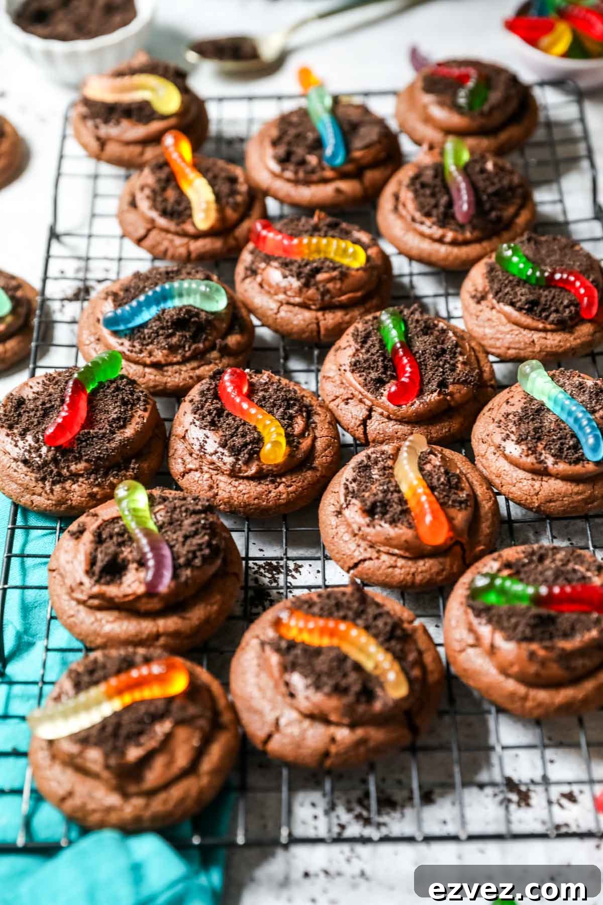 Cooling rack of dirt cookies topped with gummy worms.