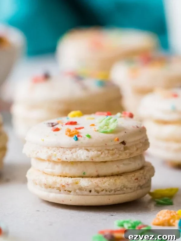 Fruity pebble macarons on a white countertop.