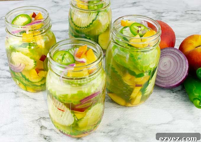 horizontal image of 4 jars of Sweet and Spicy Peach Jalapeno Pickles
