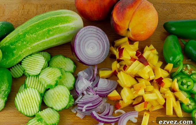 wooden cutting board with prepped ingredients for Sweet and Spicy Peach Jalapeno Pickles 