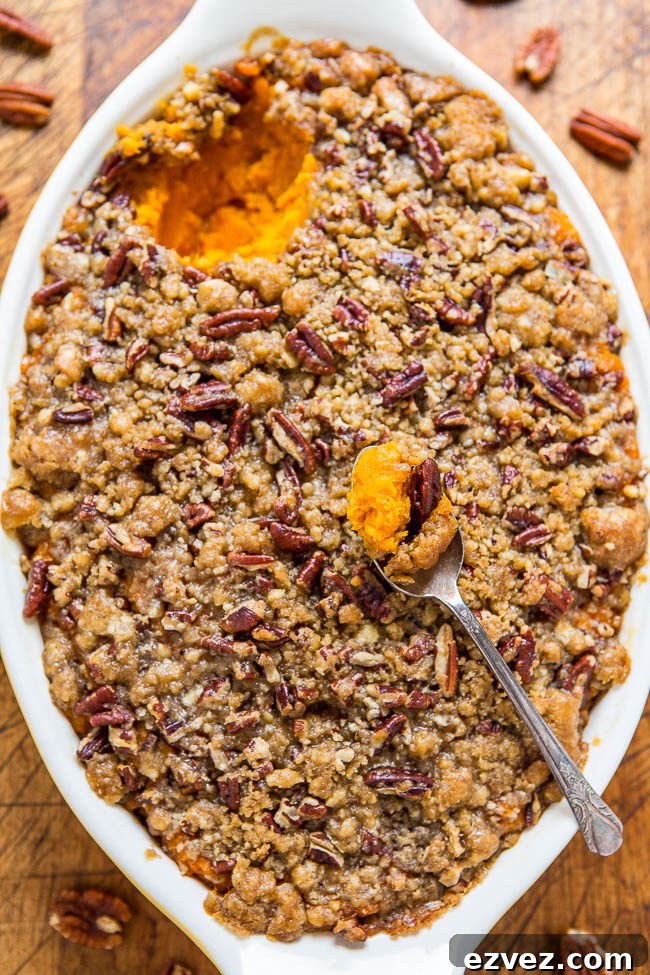 Sweet Potato Casserole with Butter Pecan Crumble Topping - The holiday classic just got even better because of the amazing topping! A buttery, brown sugary, crunch that's irresistible! Easy and you can pre-assemble to save time!!
