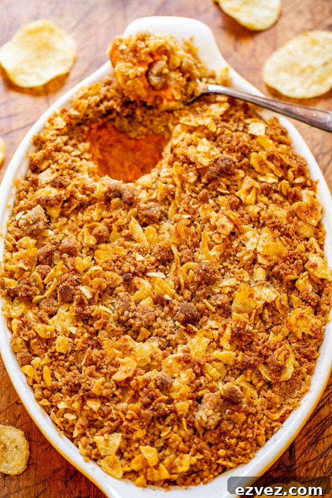 Sweet and Savory Sweet Potato Casserole — A fun and EASY twist on classic sweet potato casserole that uses potato chips in the topping for a SALTY-SWEET flavor the whole family will love!! Great for Thanksgiving and Christmas celebrations!!