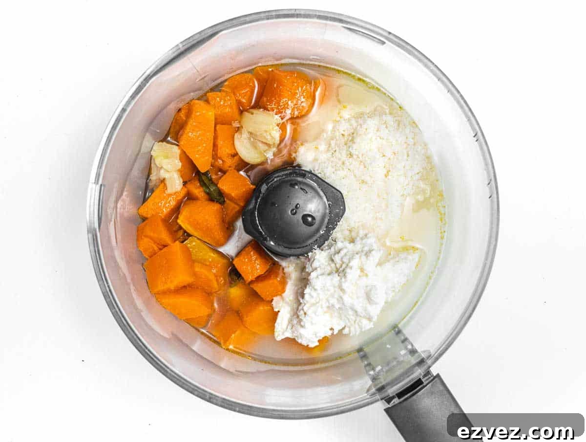 food processor with roasted pumpkin and cheeses