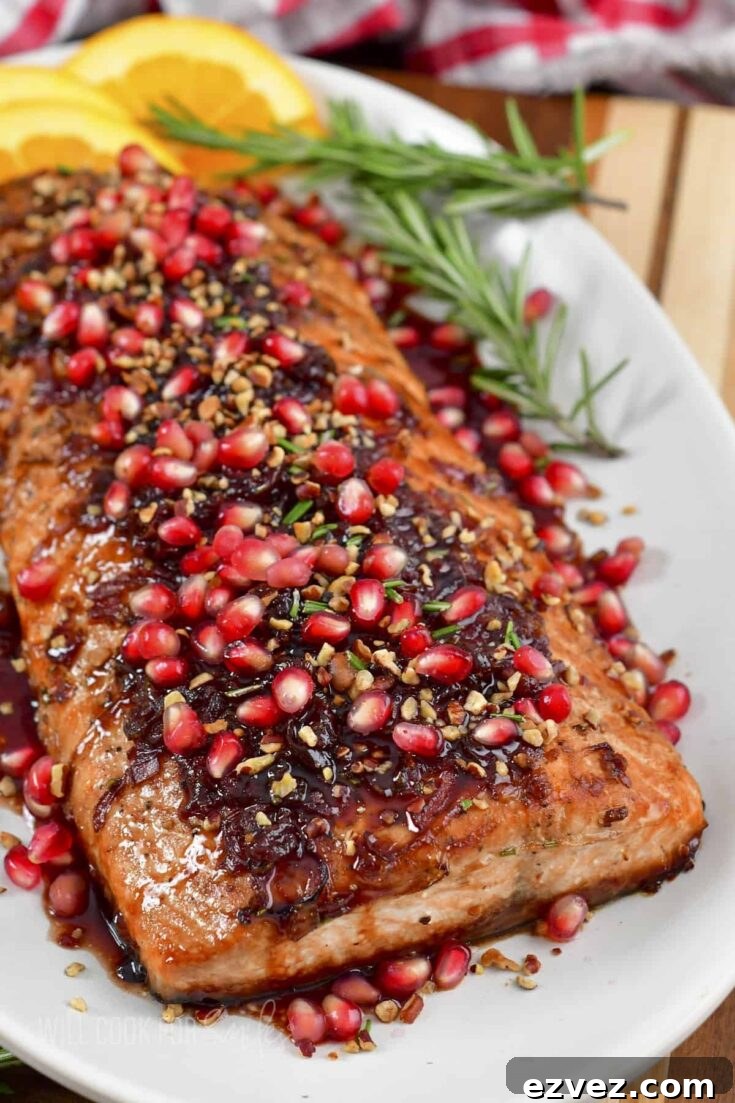Cooked whole filet presented on oval platter with Thanksgiving herbs, orange slices and a red-checked cloth decoratively in background.