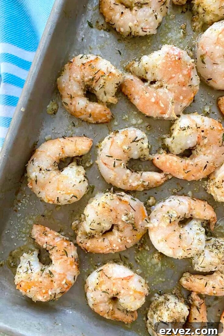 Closeup of cooked shrimp, still on baking pan.