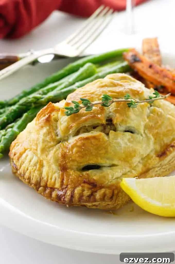 Wellington plated for Thanksgiving dinner with asparagus, carrots and a lemon wedge.