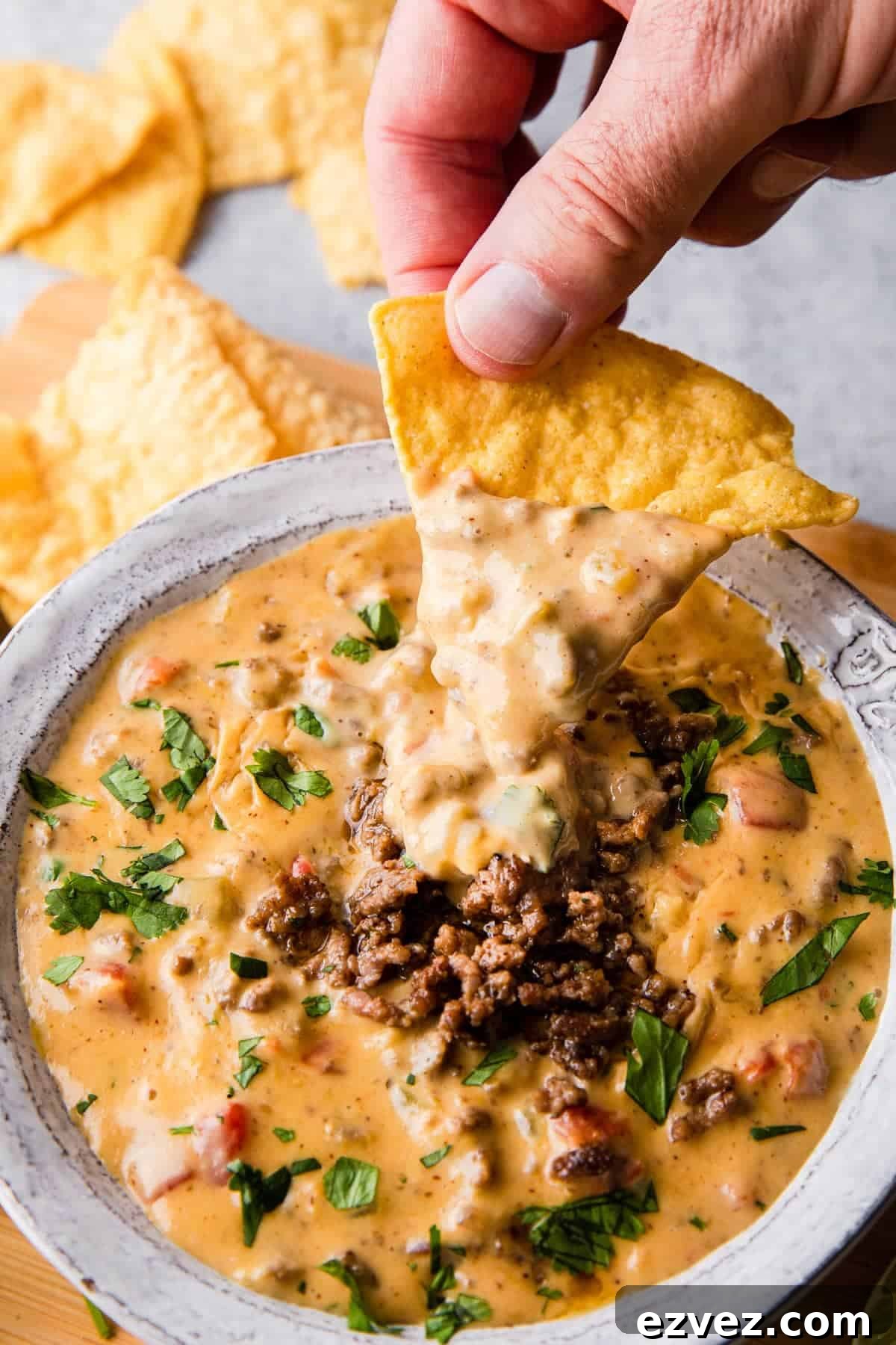 velveeta queso in a bowl with a chip dipping into it
