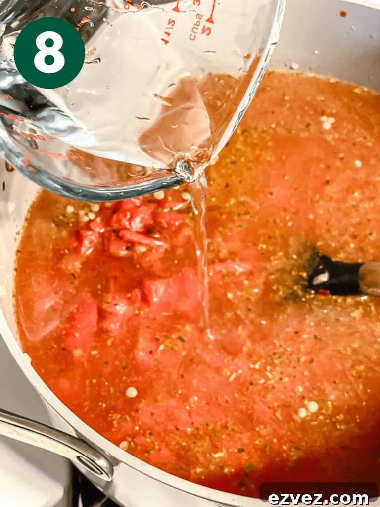 Hearty Spicy Lentil Soup Recipe with Warm Moroccan Flavors 11 process shot of adding water to pan