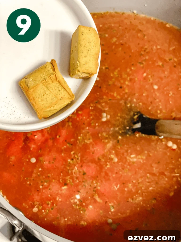 Hearty Spicy Lentil Soup Recipe with Warm Moroccan Flavors 12 process shot of adding bouillon cubes to pan