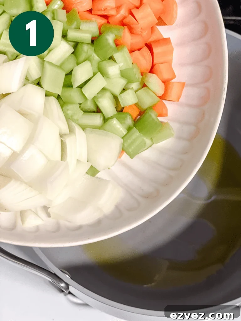 Hearty Spicy Lentil Soup Recipe with Warm Moroccan Flavors 4 process shot of adding veggies to pan