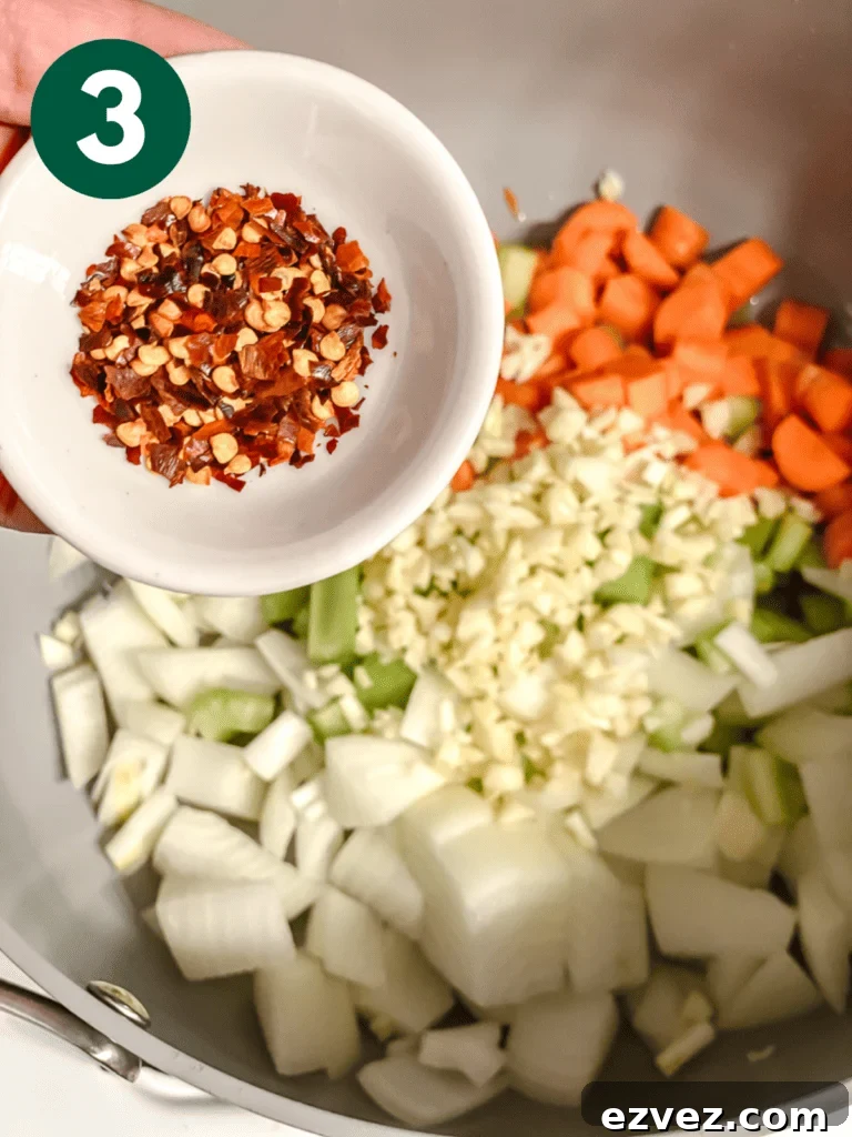 Hearty Spicy Lentil Soup Recipe with Warm Moroccan Flavors 6 process shot of adding seasonings to pan