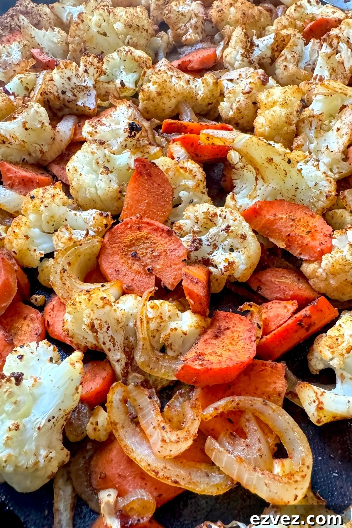 roasted cauliflower and carrots on baking sheet