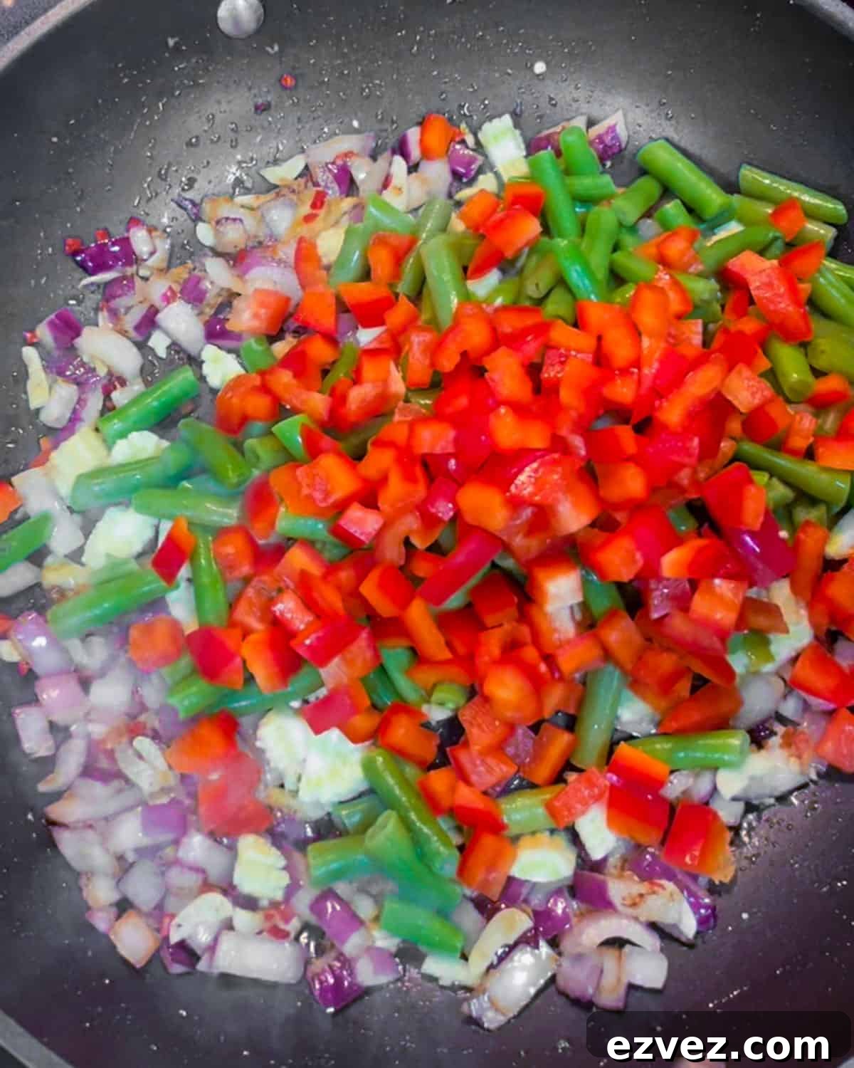 Photo of vegetables being added into the stir-fry.