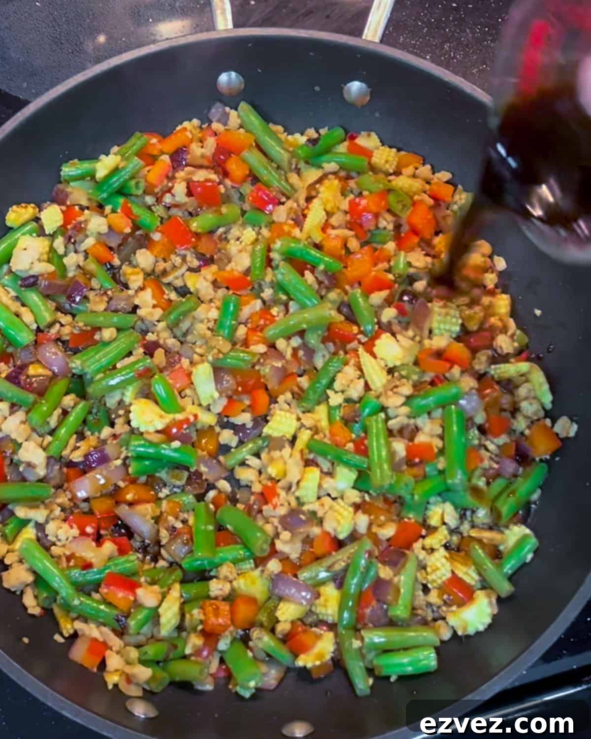 Photo of sauce being added into the stir-fry.