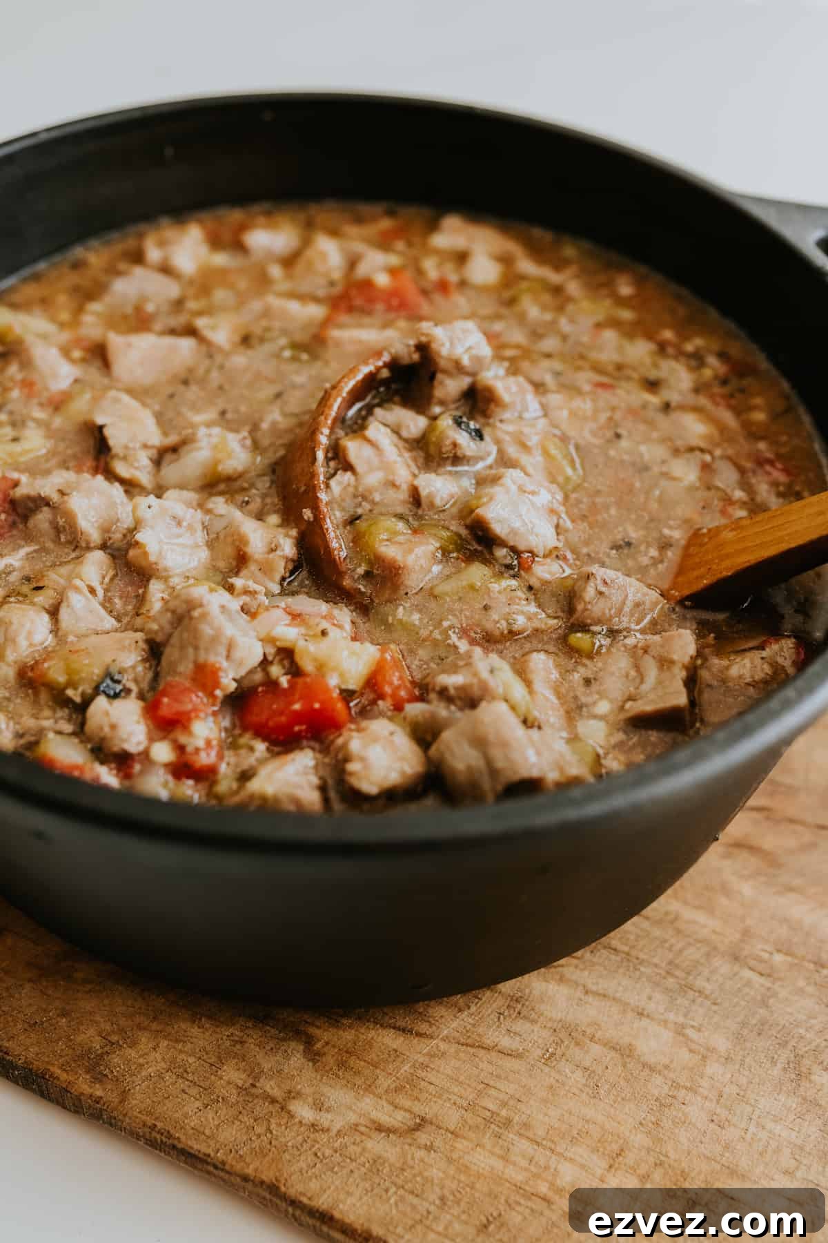Colorado-Style Green Chile Pork Roast Recipe 7 Colorado Green Chile Pork in a black cast iron pot packed with peeled, roasted chiles and succulent pork to create an easy and warming stew.