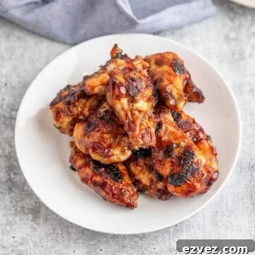A plate filled with BBQ wings.