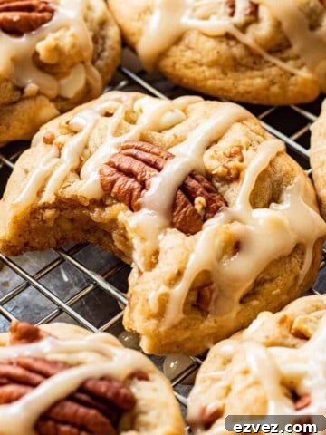 Baked Maple Cookies on metal pan with bite out of one.