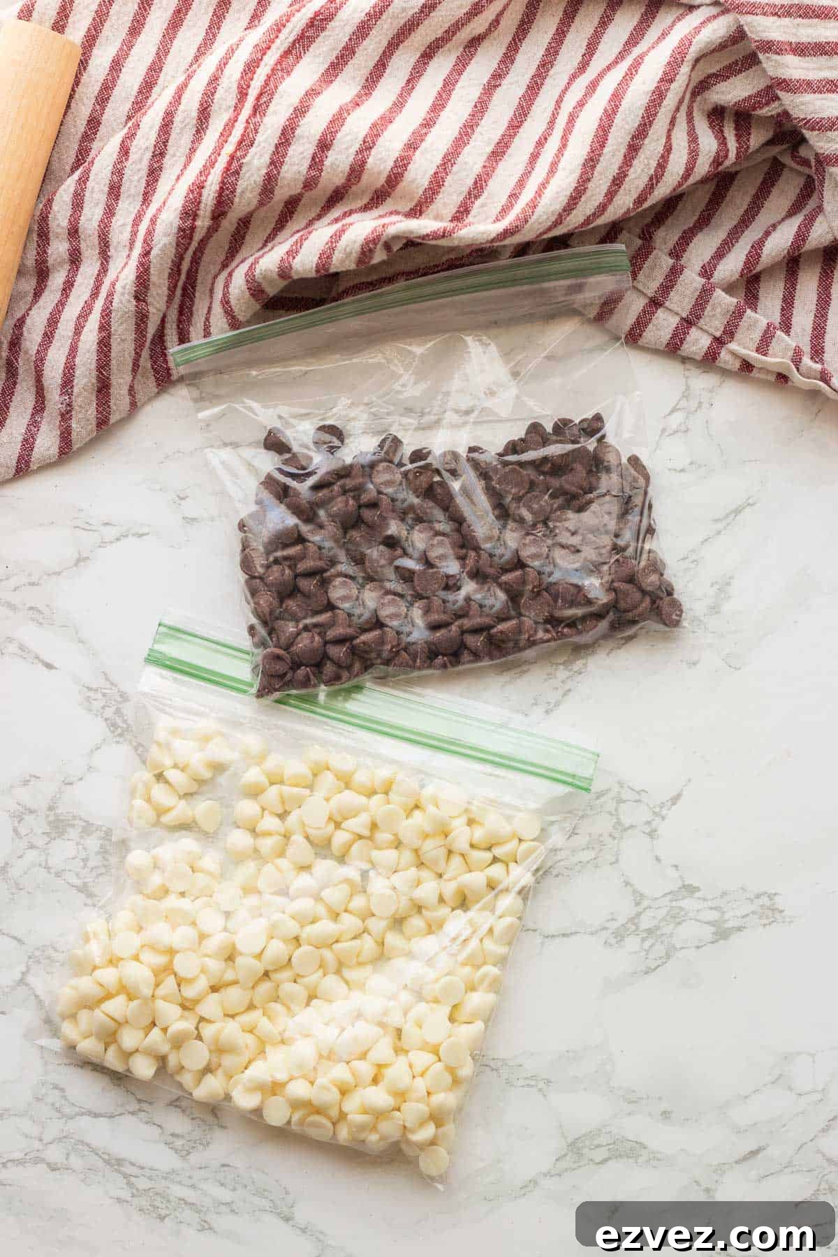 Spooky Halloween Pudding Cups Recipe for Party Treats 5 Chocolate chips and white chocolate chips in plastic bags on marble countertop.