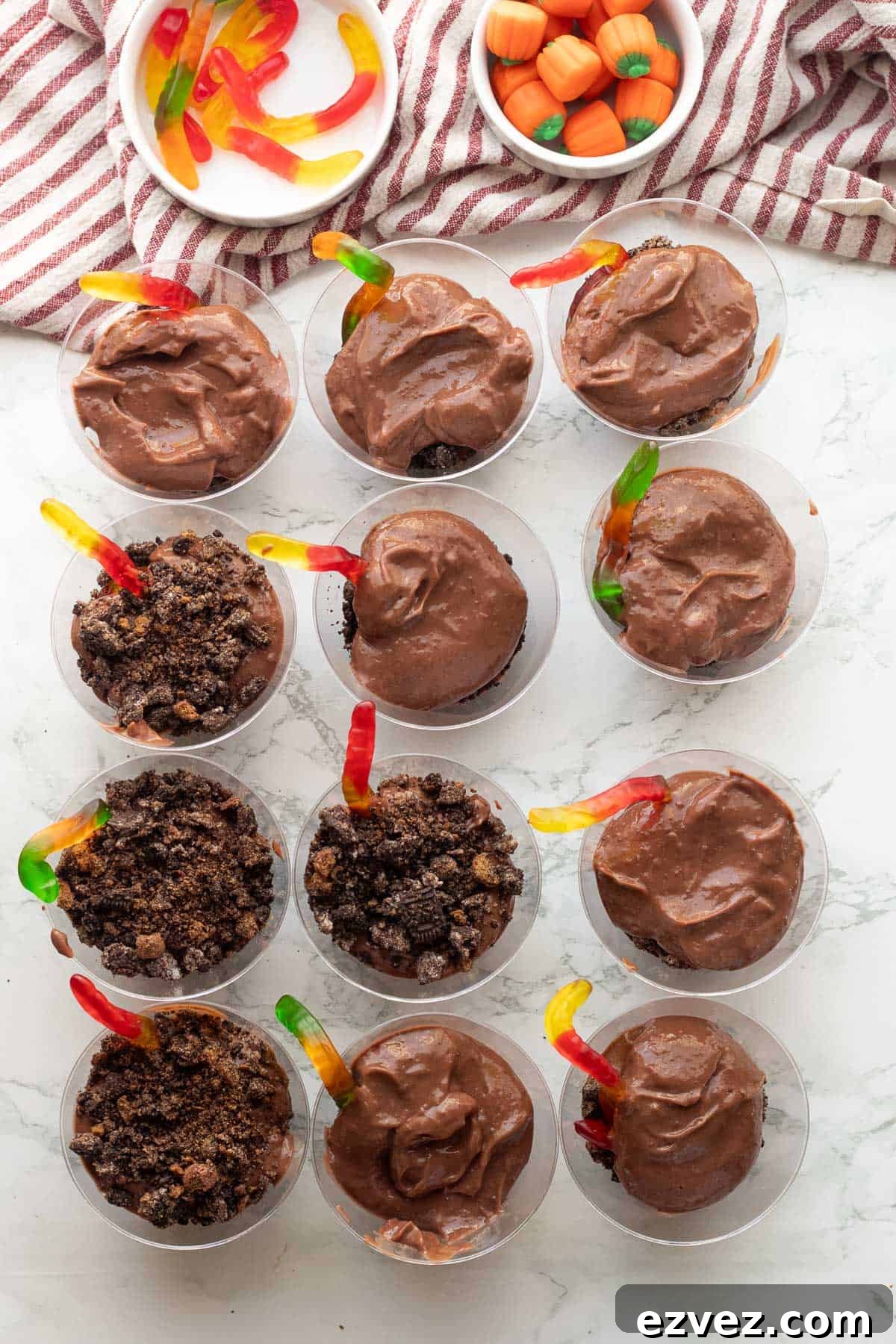 Spooky Halloween Pudding Cups Recipe for Party Treats 10 Pudding and oreos with gummy worms in clear plastic cups.