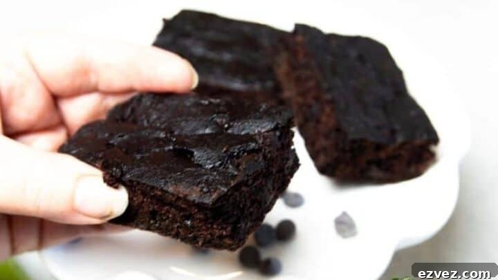 A piece of chocolate zucchini brownie on a white plate