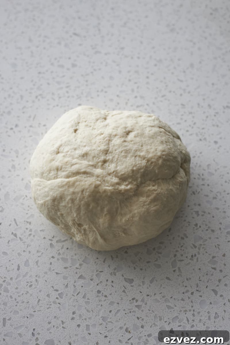 Smooth dough on a work surface after kneading.