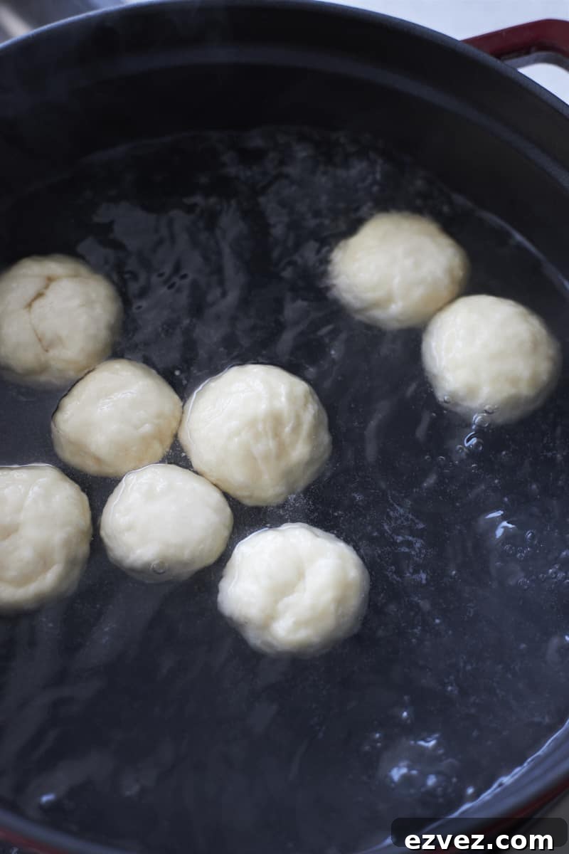Bagel bites boiling in a large pot.