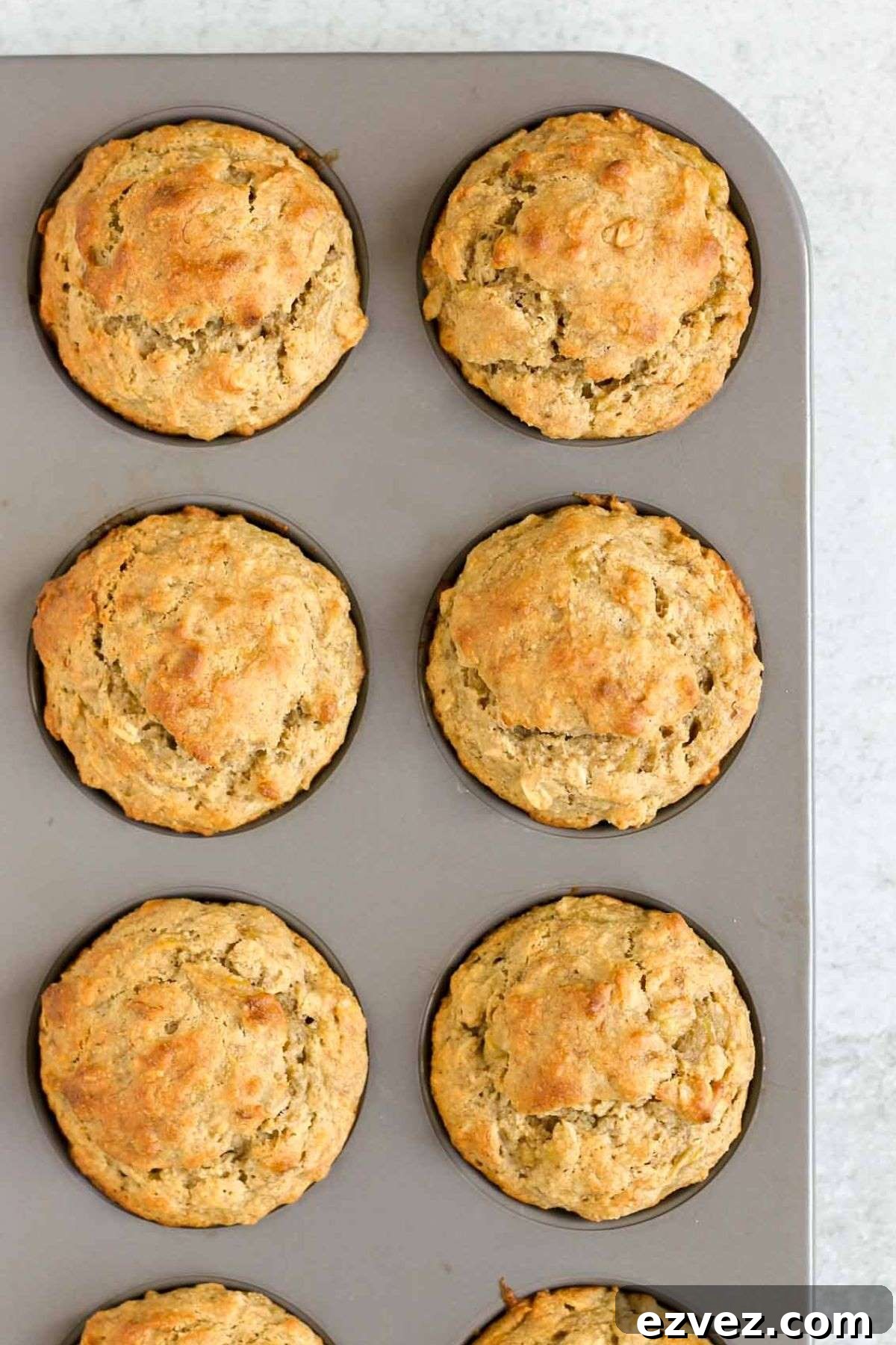 Banana muffins in a metal muffin pan.