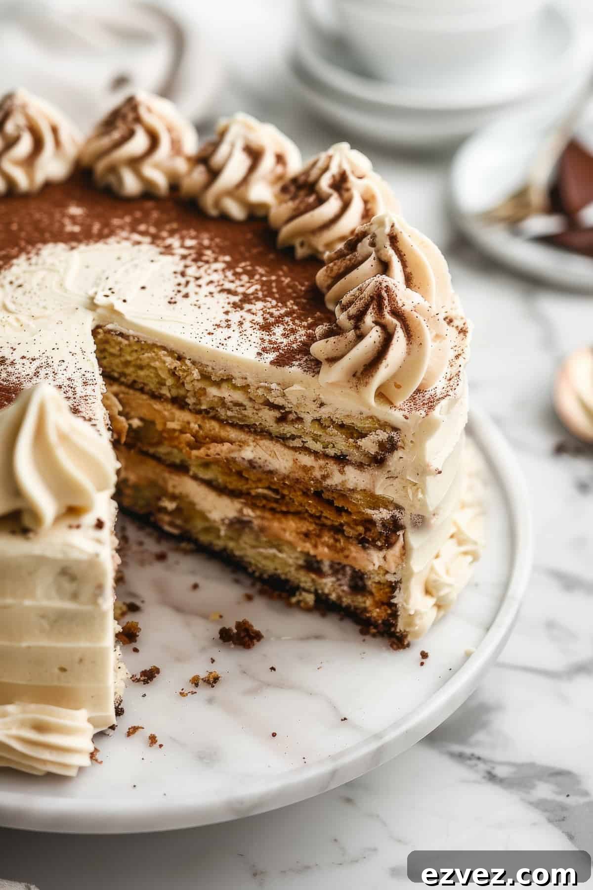Tiramisu layer cake with frosting and cocoa powder.