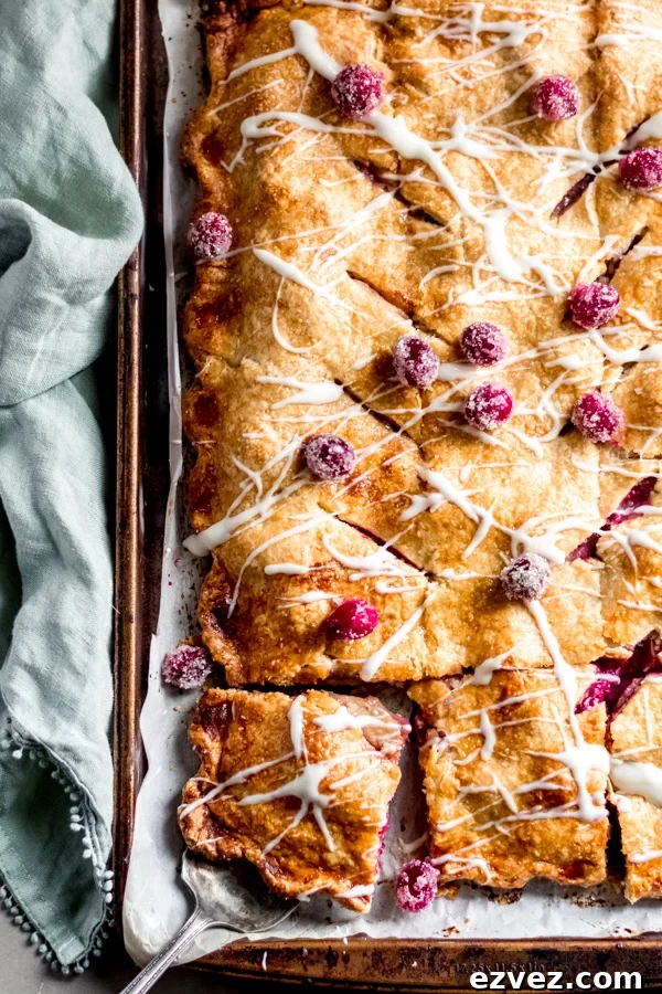 Cranberry apple slab pie with maple glaze on a tray.