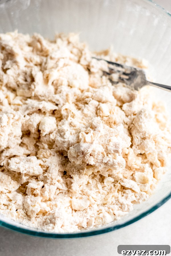 Butter and flour mixture crumbled together in a bowl with a fork.