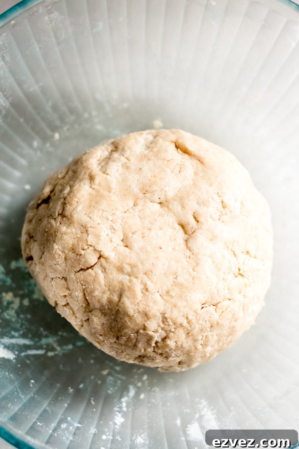 Ball of dough in a glass bowl.