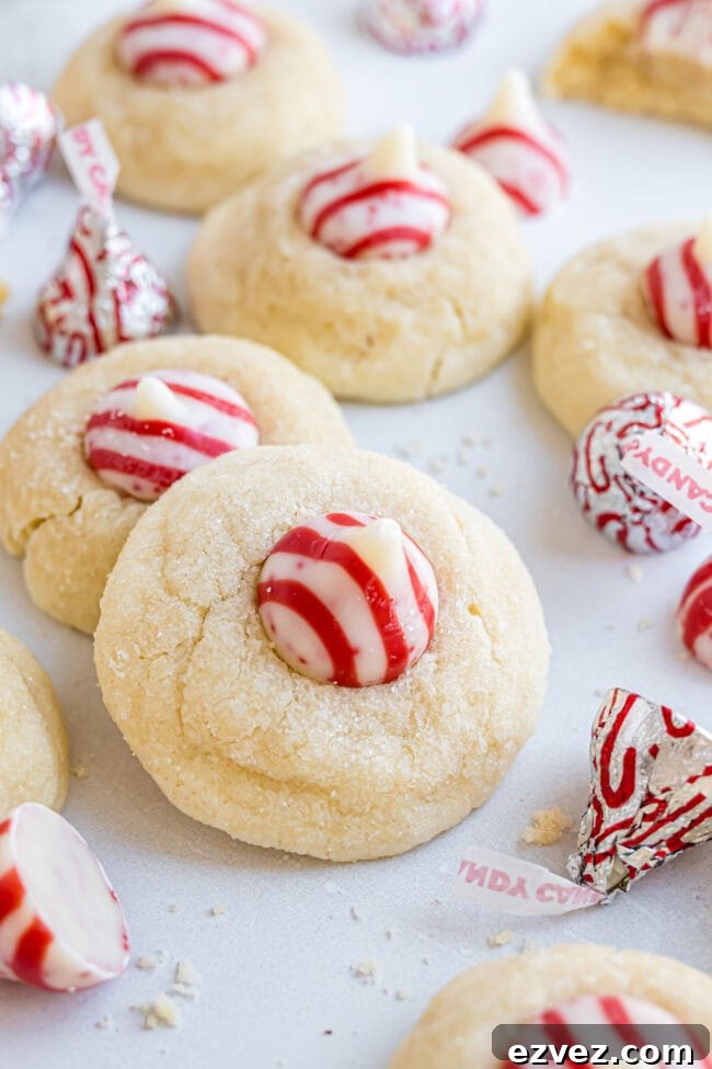 Holiday cookie pile featuring Candy Cane Kiss Cookies on a marble surface.