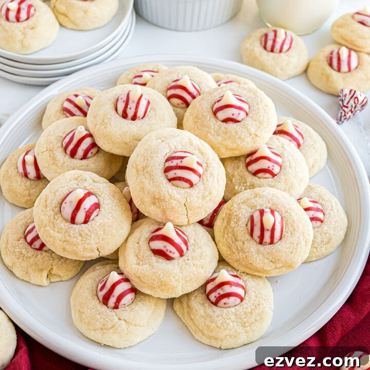 Side view of a plate stacked with Candy Cane Kiss Cookies, ready for serving.