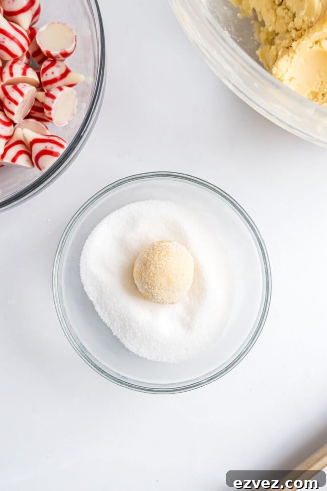 Cookie dough ball in granulated sugar before baking.