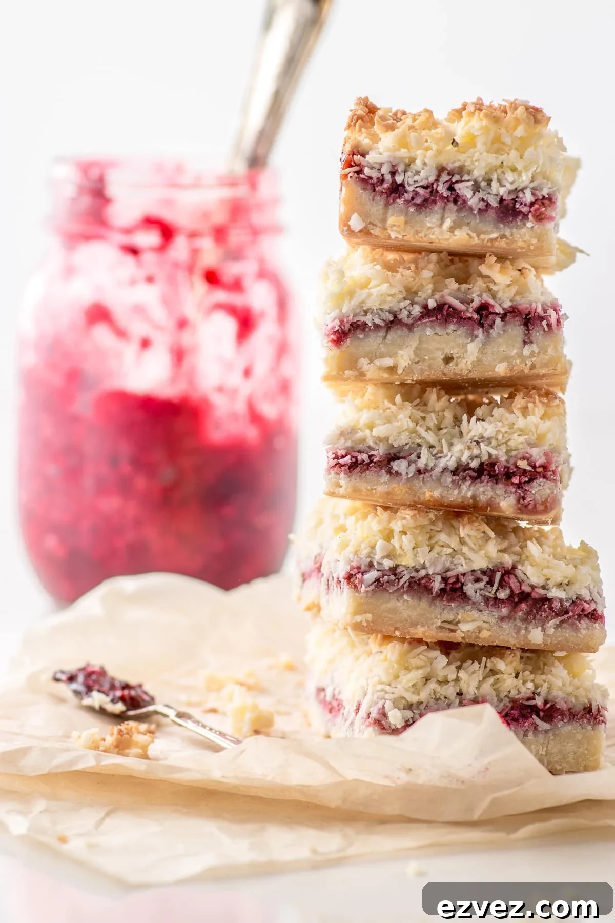 A stack of freshly made low carb raspberry coconut slice bars, perfect for Valentine's day.