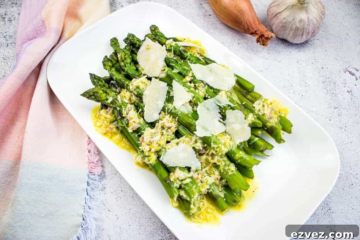 Asparagus with Lemon and Parmesan on a white platter.