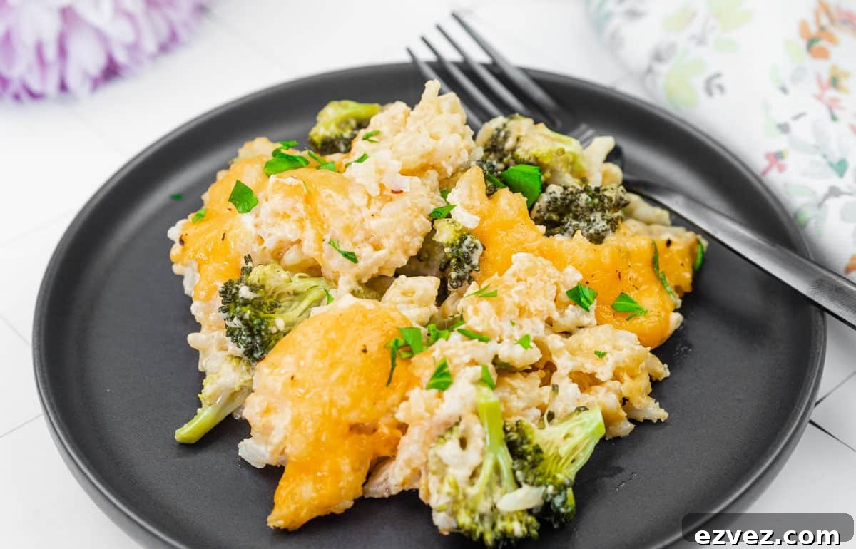 A serving of Broccoli Rice Casserole with Fresh Broccoli on a black plate.