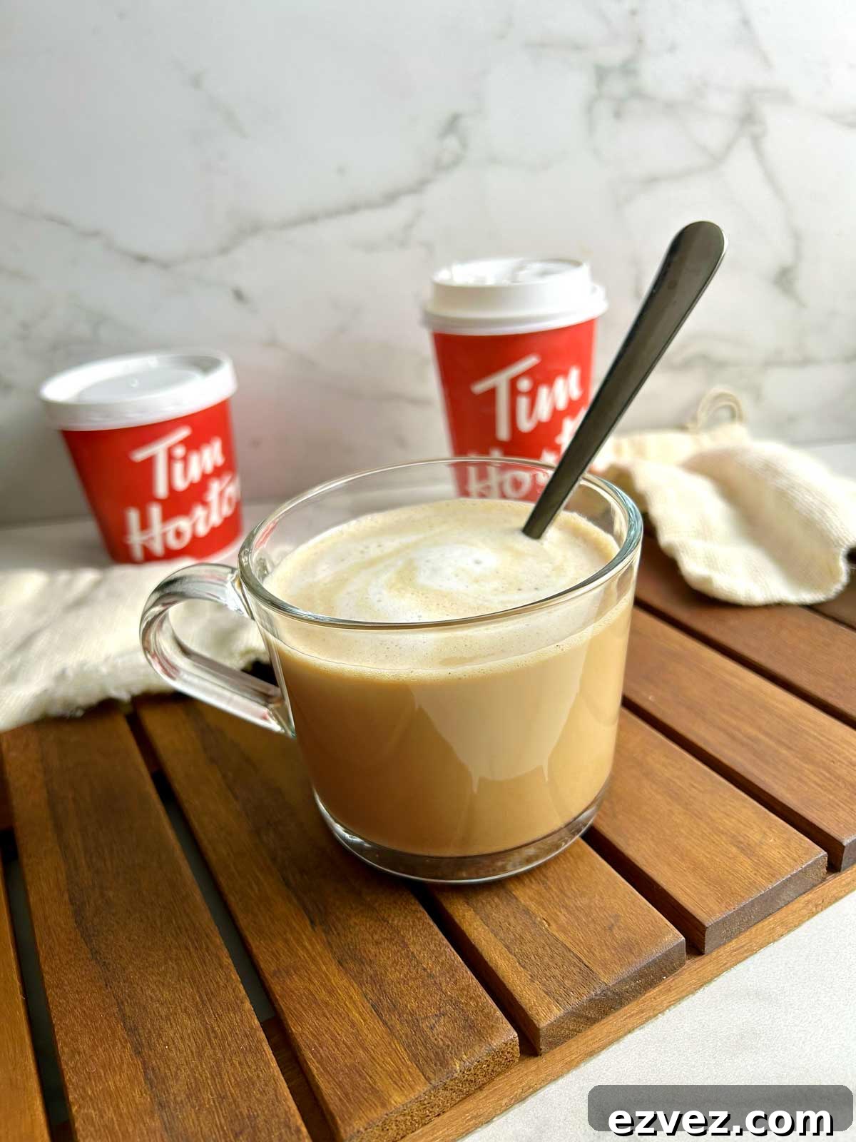cup of french vanilla coffee with Tim Hortons containers in the background