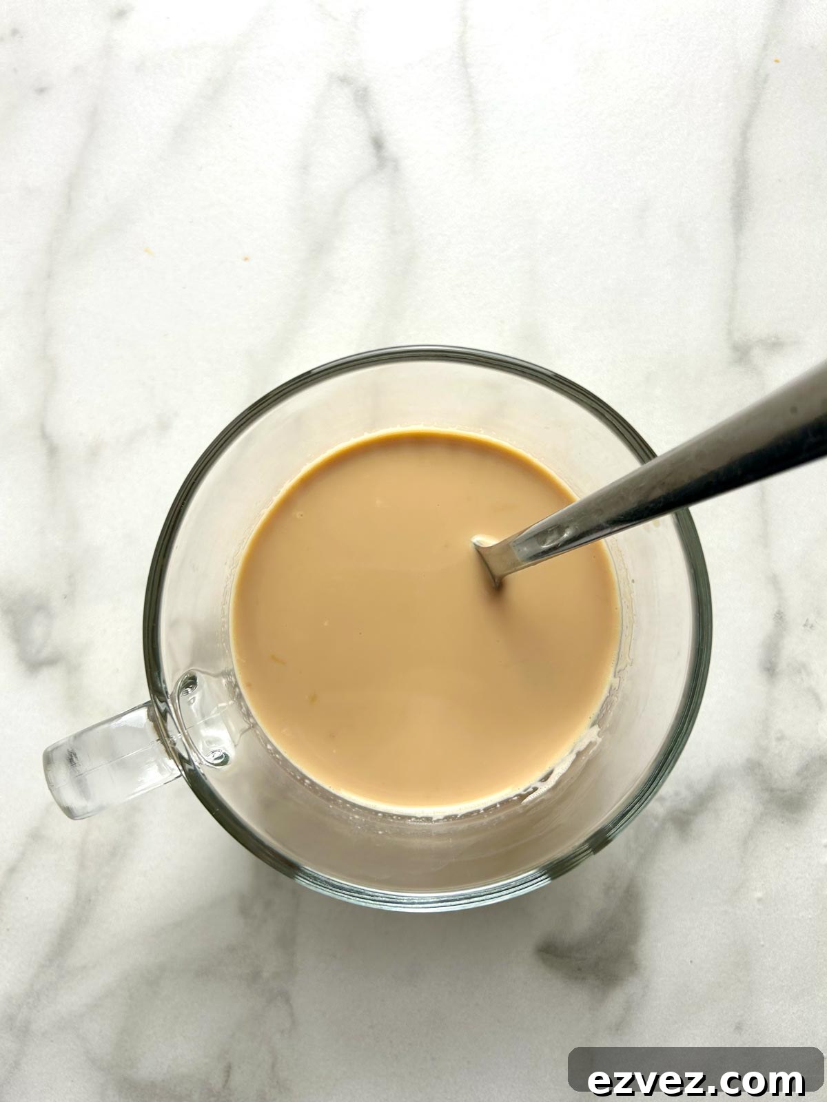stirring milk into hot coffee