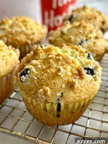 blueberry muffins resting on rack with Tim Hortons cups in background