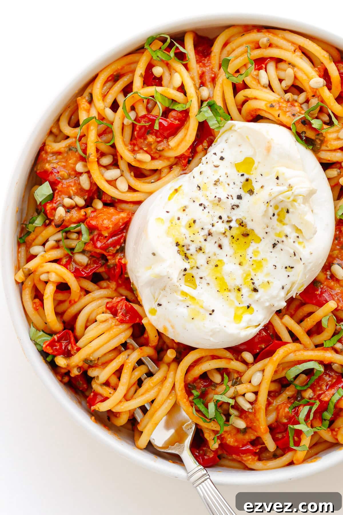 Creamy Burrata Pasta with Cherry Tomato Garlic Butter Sauce 11 Cherry tomato pasta topped with a ball of burrata and garnished with pine nuts and fresh basil.