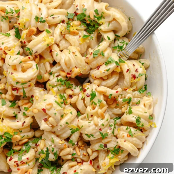 Creamy Burrata Pasta with Cherry Tomato Garlic Butter Sauce 13 Closeup of tahini pasta in a white bowl with fork.