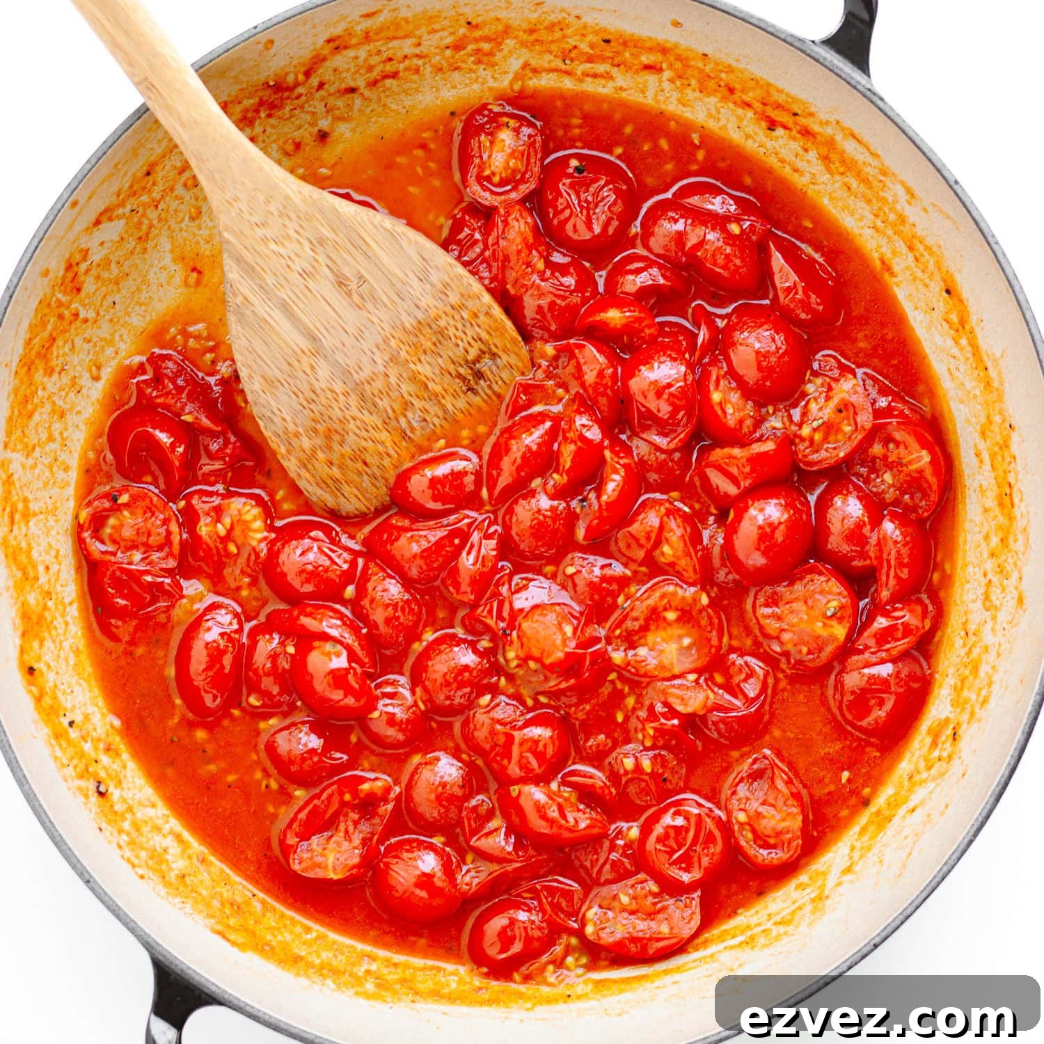 Creamy Burrata Pasta with Cherry Tomato Garlic Butter Sauce 5 Cherry tomatoes being cooked down for sauce in a large pan.