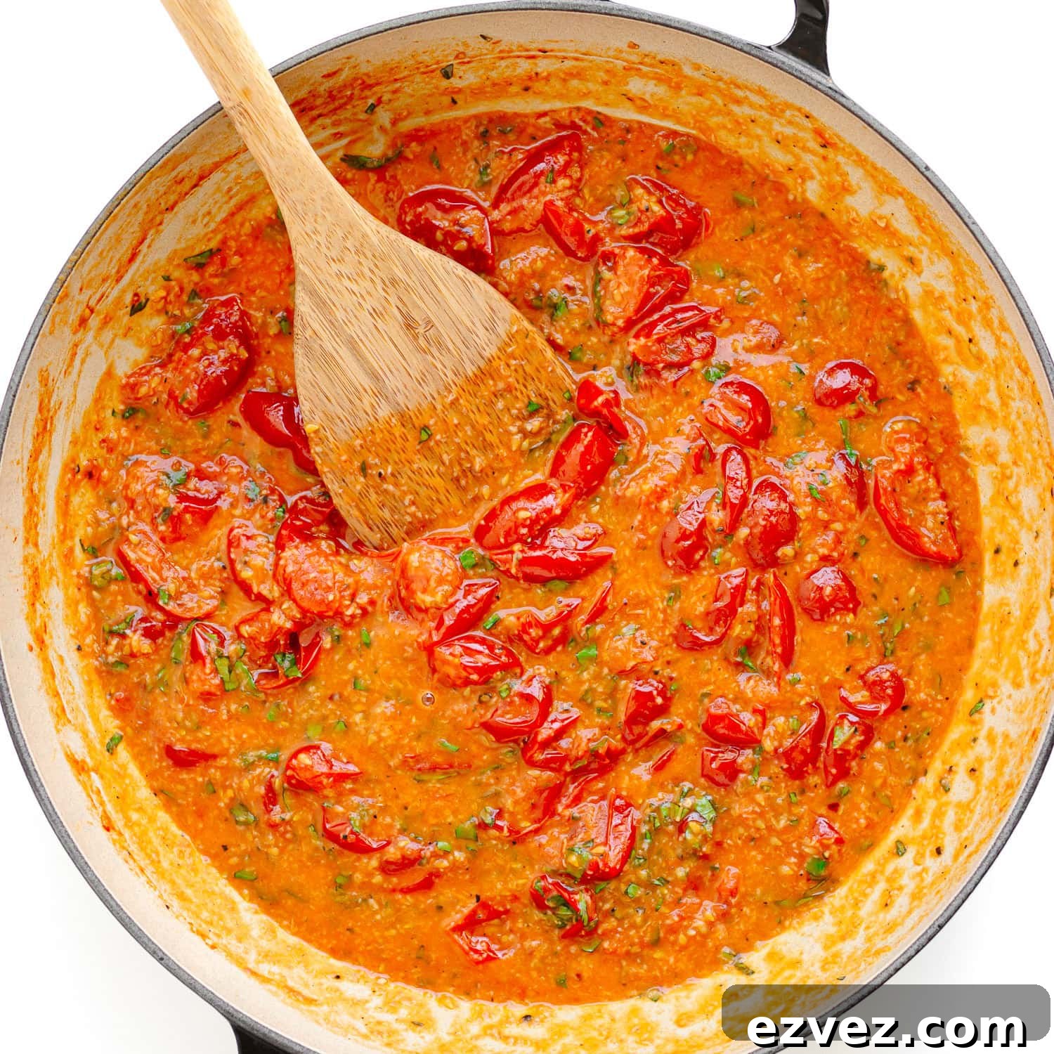 Creamy Burrata Pasta with Cherry Tomato Garlic Butter Sauce 7 Cherry tomato garlic butter sauce in a large pan with a wooden spoon.