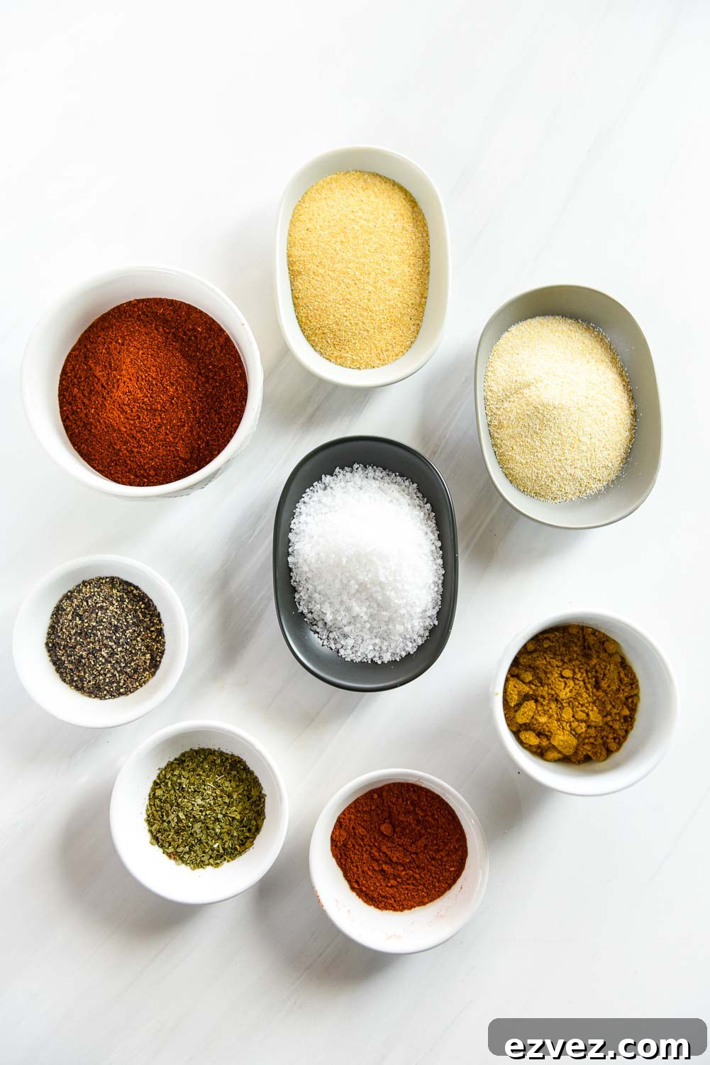 ramekins with dried spices including garlic powder, onion powder, cumin, paprika, cilantro, black pepper, salt and chili powder