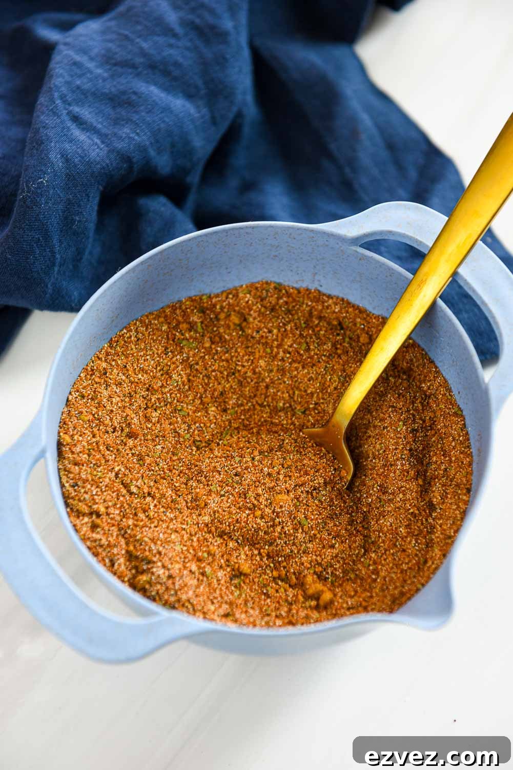 blue mixing bowl filled with homemade fajita seasoning